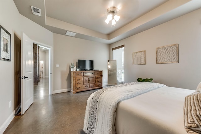 bedroom featuring a raised ceiling and ceiling fan