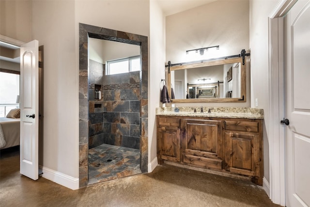 bathroom featuring a tile shower and vanity