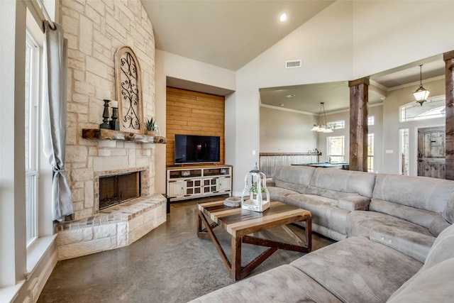 living room featuring ornate columns, a stone fireplace, high vaulted ceiling, crown molding, and pool table