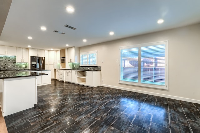 kitchen featuring sink, stainless steel fridge, white cabinetry, tasteful backsplash, and dark hardwood / wood-style flooring