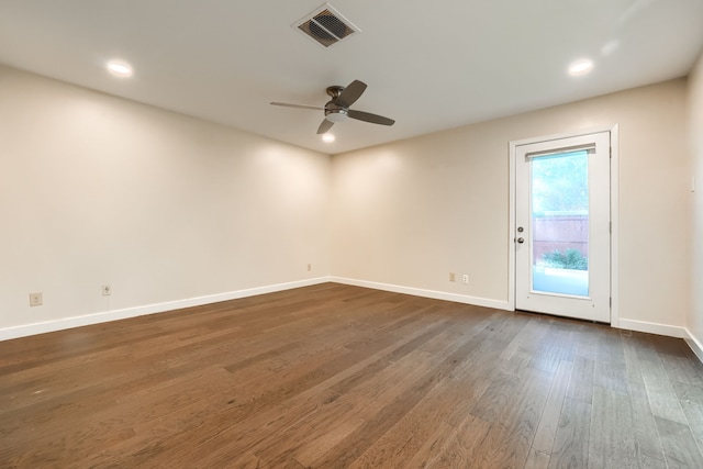 empty room featuring dark wood-type flooring and ceiling fan