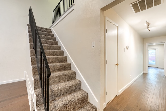 stairs with hardwood / wood-style flooring