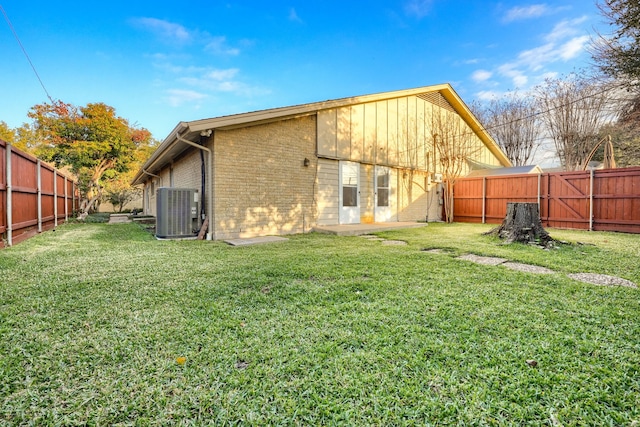 back of property with a yard and cooling unit