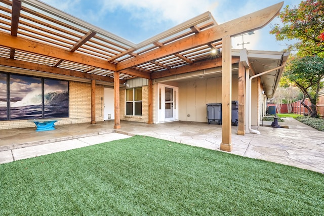 back of house featuring a pergola, a patio, and a yard