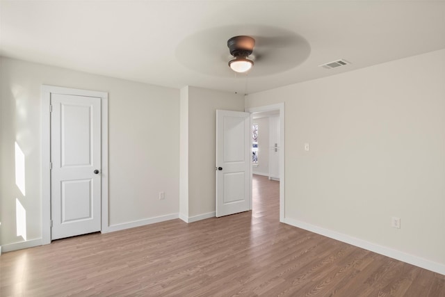 empty room featuring ceiling fan and light wood-type flooring