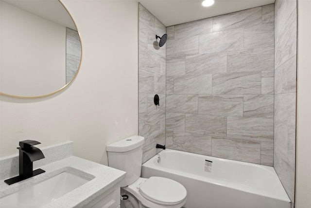 full bathroom with vanity, tiled shower / bath combo, and toilet