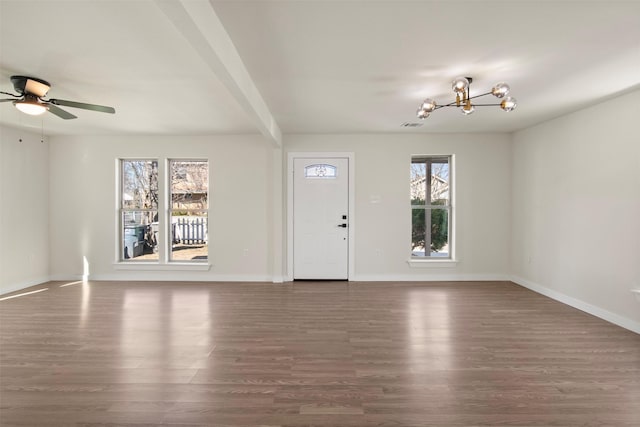 entrance foyer featuring dark wood-type flooring, plenty of natural light, and ceiling fan with notable chandelier