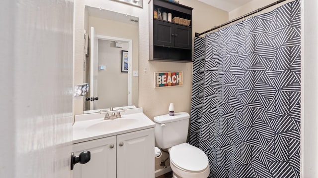 bathroom with vanity, toilet, and a shower with shower curtain