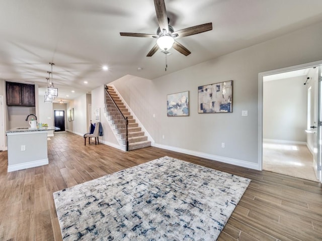 living room with sink, hardwood / wood-style floors, and ceiling fan