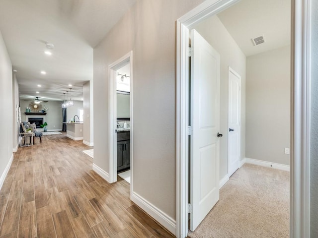 hall with light hardwood / wood-style flooring