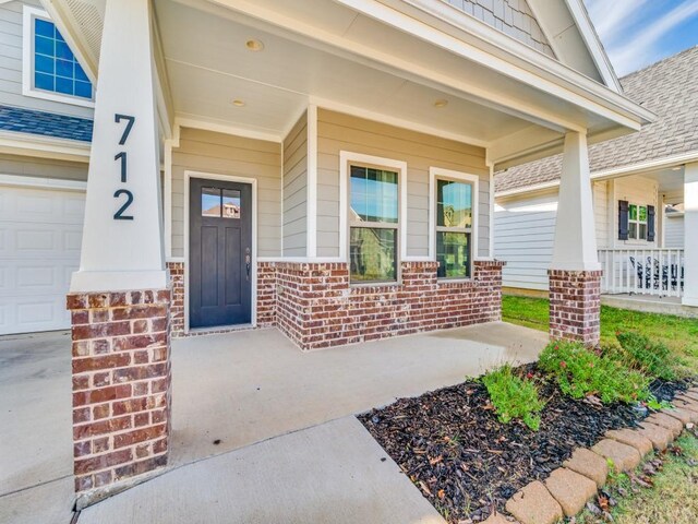 view of exterior entry with covered porch