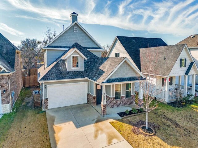 craftsman house with a front lawn, a porch, and a garage