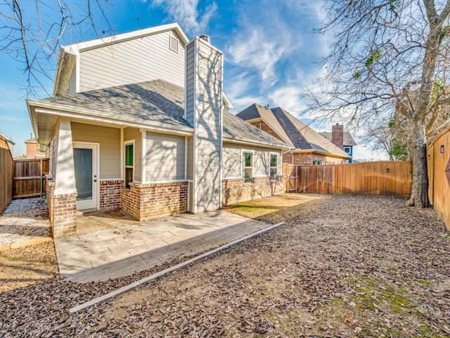 back of house with a patio