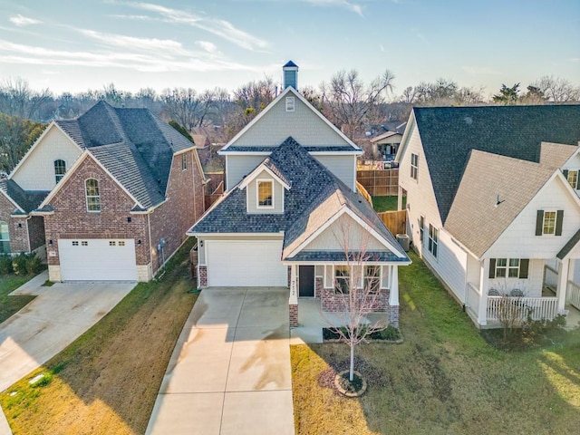 view of front of home featuring a garage, a porch, and a front yard