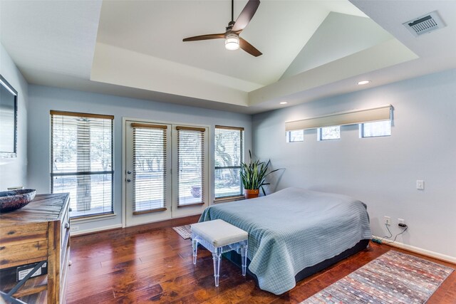 bedroom with access to exterior, a raised ceiling, ceiling fan, and lofted ceiling