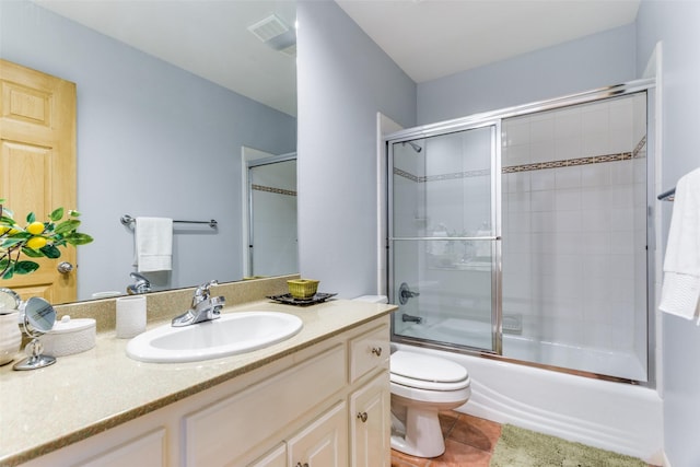 full bathroom with tile patterned floors, toilet, vanity, and combined bath / shower with glass door