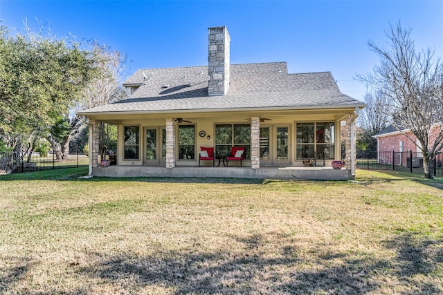 back of property featuring ceiling fan, a yard, and a patio