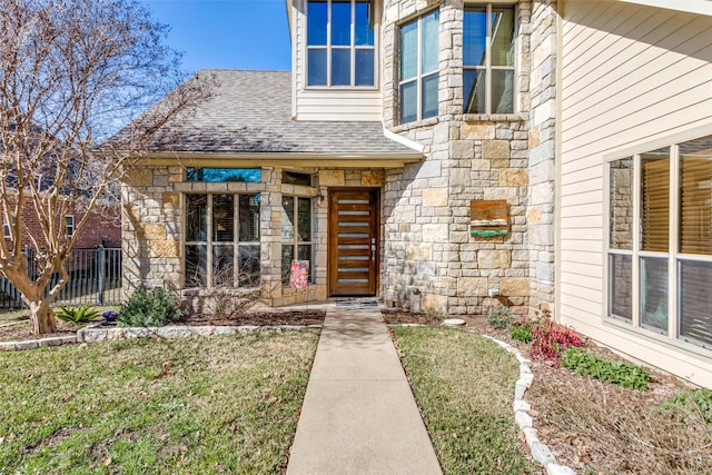 view of exterior entry with a yard