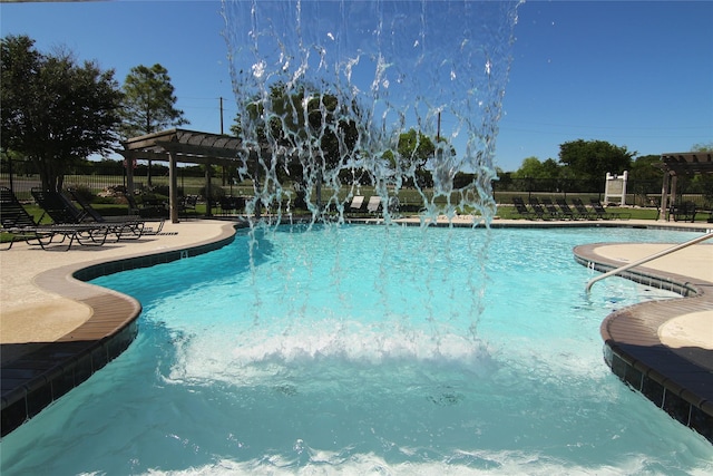 view of swimming pool with a pergola, a patio area, and pool water feature