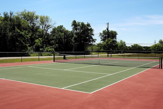 view of tennis court featuring basketball hoop