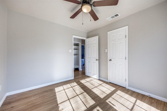 unfurnished bedroom with a closet, ceiling fan, and light hardwood / wood-style flooring