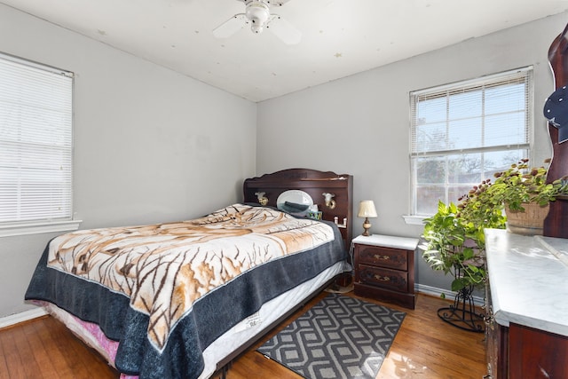 bedroom with wood-type flooring and ceiling fan