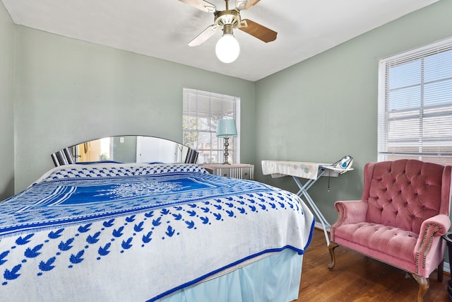 bedroom with hardwood / wood-style floors and ceiling fan