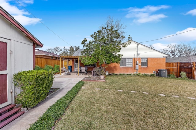 view of yard with central AC and a patio