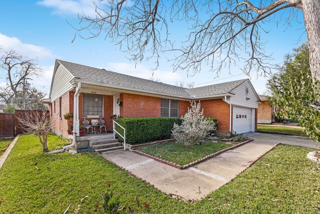 ranch-style house with covered porch, a garage, and a front lawn