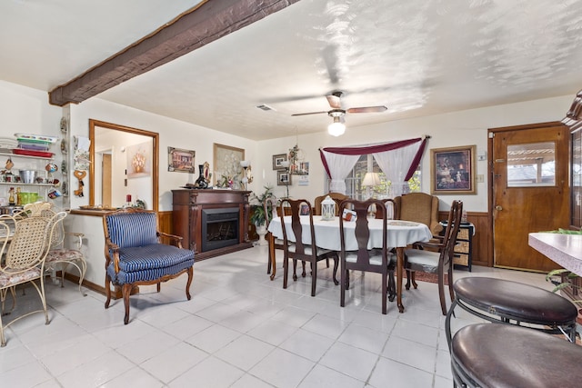 dining room with beam ceiling and ceiling fan