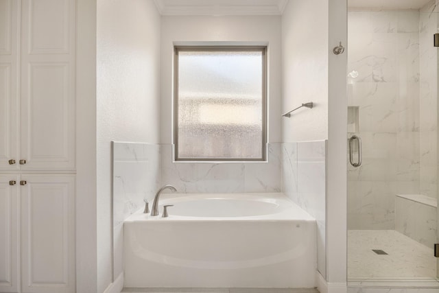 bathroom with a wealth of natural light, crown molding, and independent shower and bath