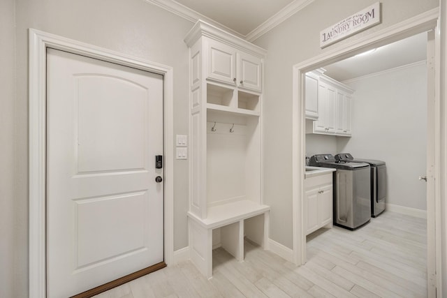 mudroom featuring washer and dryer, light wood-type flooring, and ornamental molding