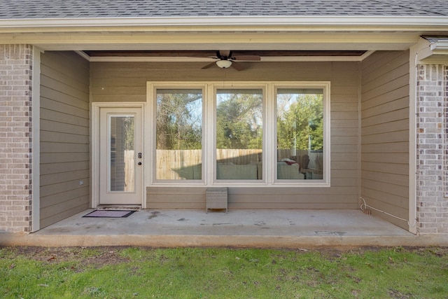 doorway to property with ceiling fan and a patio area