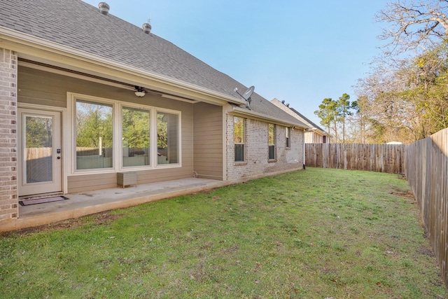 back of property featuring a lawn and a patio