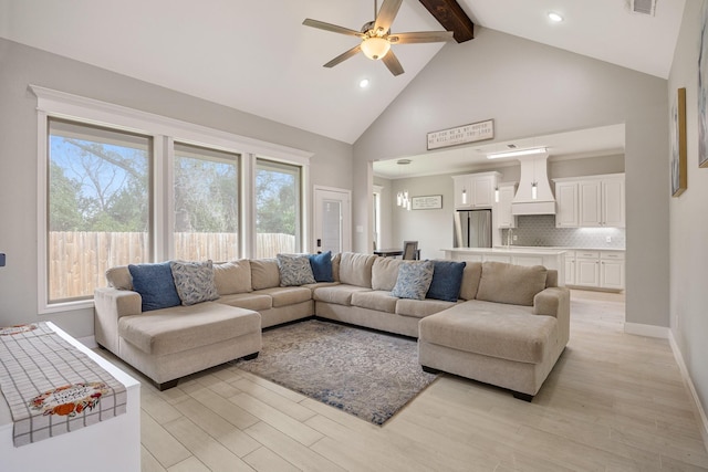 living room with ceiling fan, light hardwood / wood-style flooring, beamed ceiling, and high vaulted ceiling