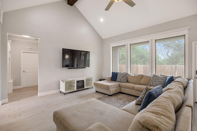 living room with ceiling fan, light hardwood / wood-style flooring, beamed ceiling, and high vaulted ceiling