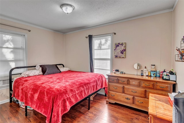 bedroom with crown molding, dark wood-type flooring, and a textured ceiling