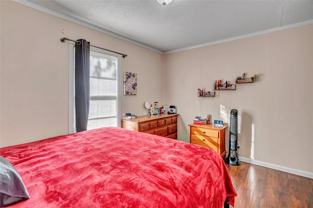 bedroom with crown molding, a textured ceiling, and hardwood / wood-style flooring