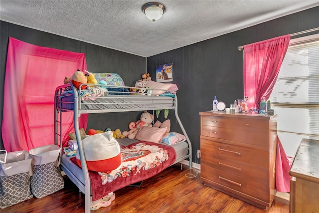 bedroom with dark wood-type flooring and a textured ceiling