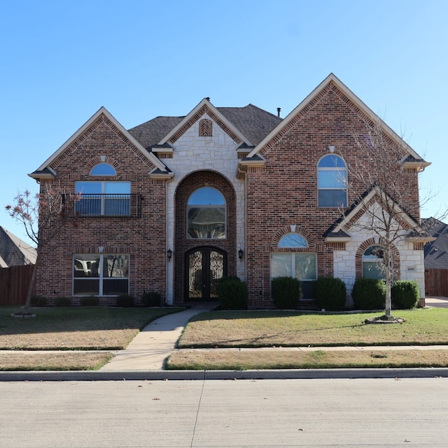 view of property with a front yard and french doors