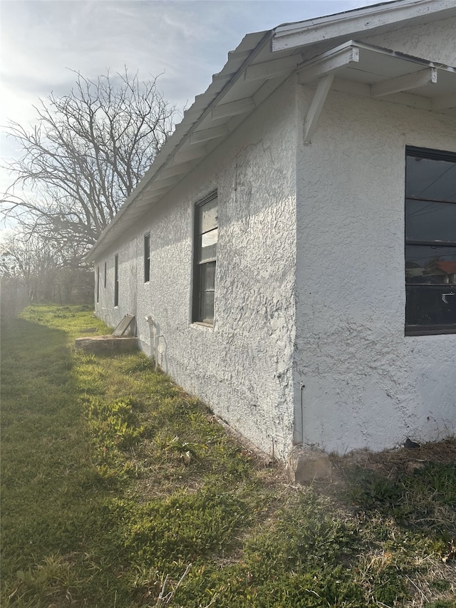 view of property exterior with a lawn