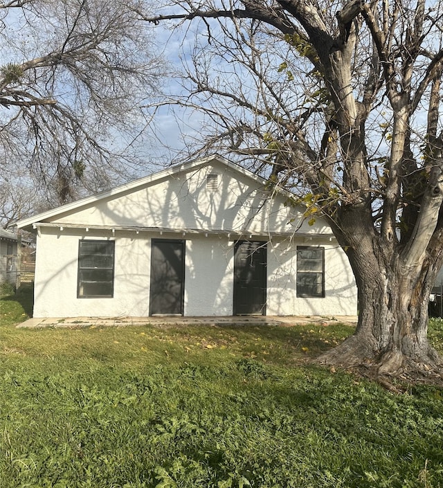 back of house with a yard