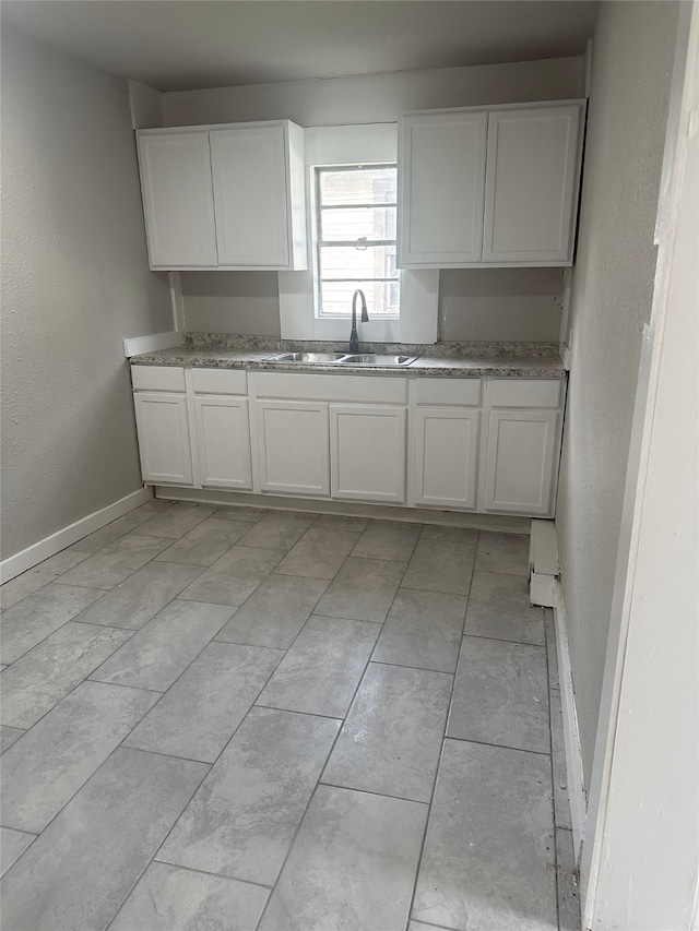 kitchen with white cabinetry and sink