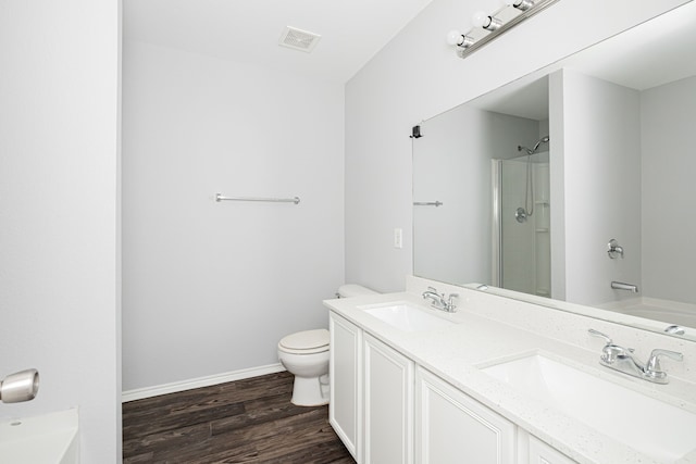 full bathroom with toilet, hardwood / wood-style flooring, plus walk in shower, and vanity