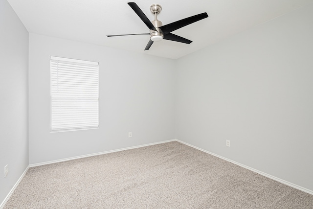 spare room with ceiling fan and carpet