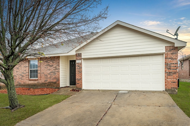 single story home featuring a garage and a lawn