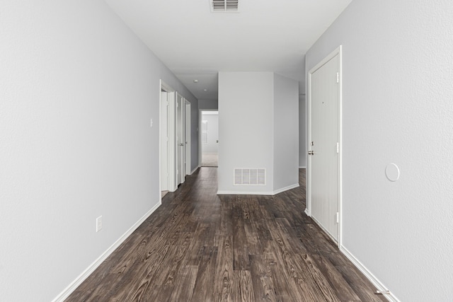 hallway with dark hardwood / wood-style flooring