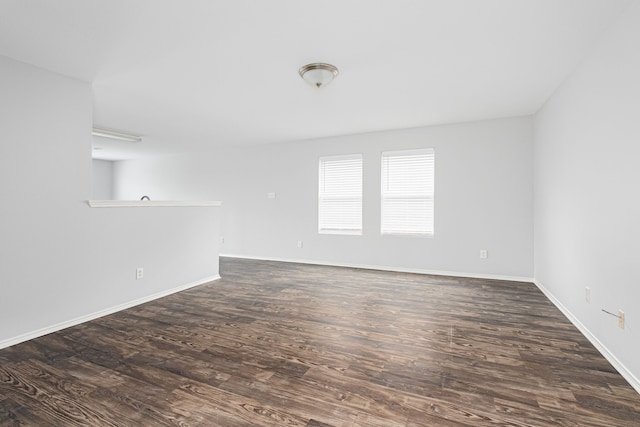 unfurnished room with dark wood-type flooring