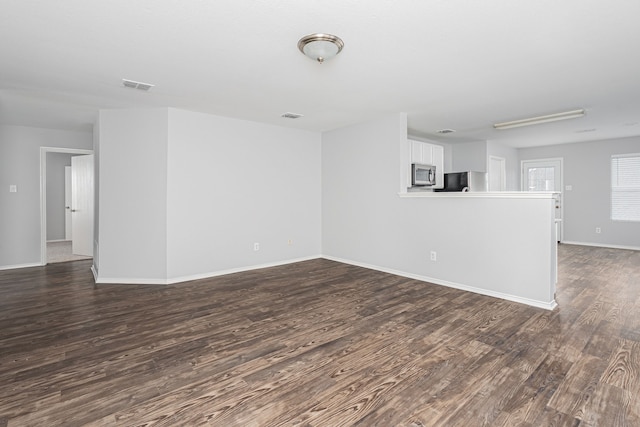 spare room featuring dark hardwood / wood-style flooring