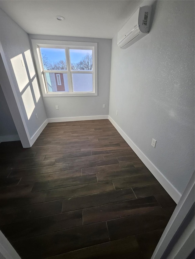 interior space featuring dark wood-type flooring and a wall mounted air conditioner